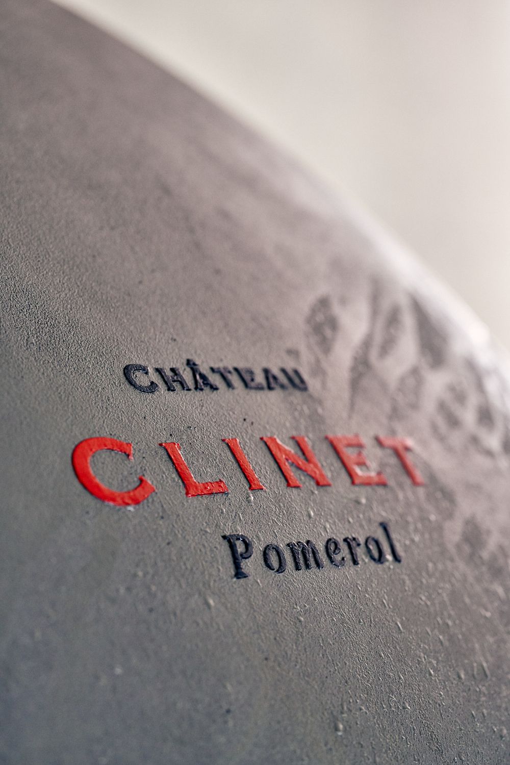 Close-up of the Clinet logo showing condensation on a concrete globe vat.