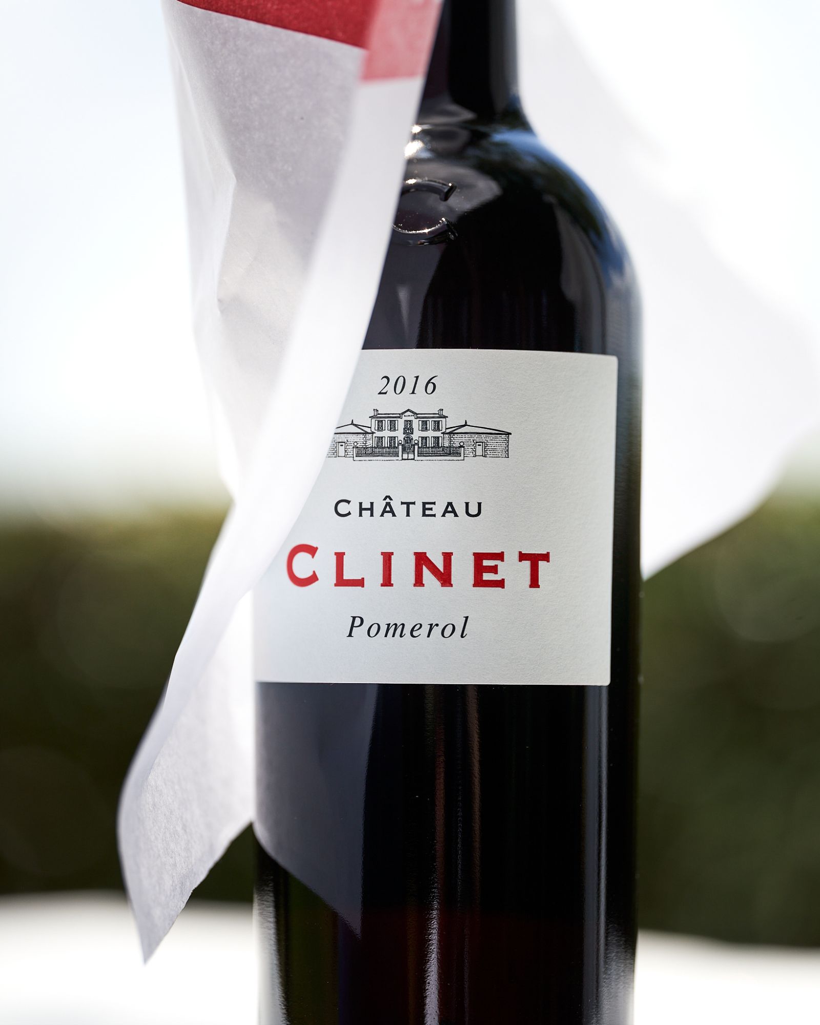 Close-up of a Clinet bottle label, white paper surrounding it like a veil.